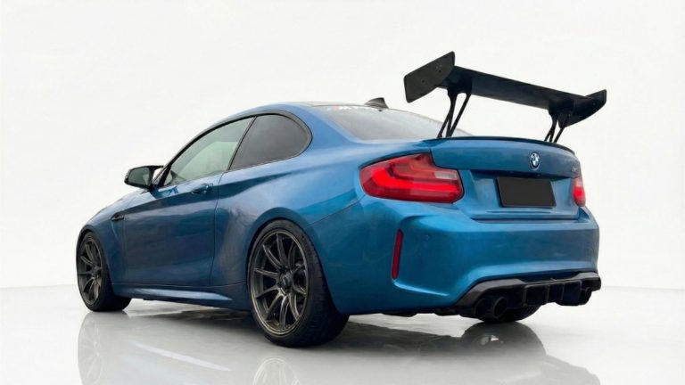 BMW F87 M2 Rear view of the BMW M2 featuring a large carbon rear wing for downforce and a high-performance REMUS exhaust system.