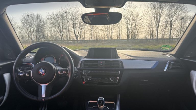 BMW F21 120i Driver's cockpit view of the BMW 120i rental car, featuring an 8-speed automatic transmission for easy handling on track.